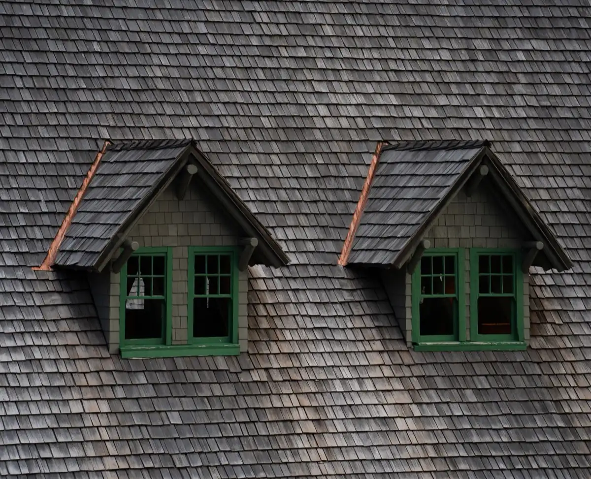 Dormers on a shingle roof in Missoula, MT, where step flashing and kickout flashing carry water past the walls